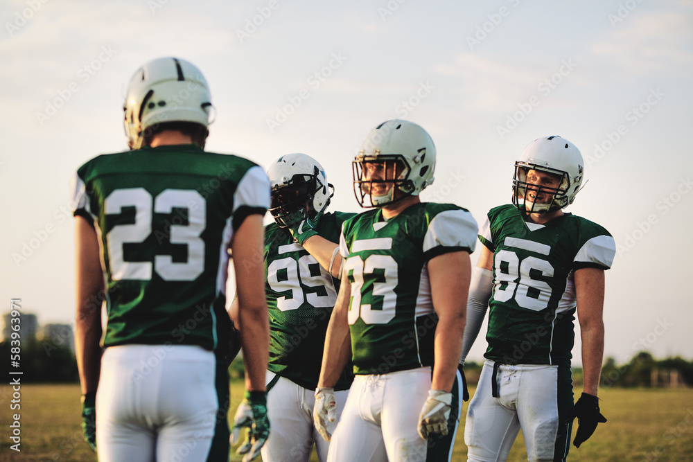 American football team talking during practice American football team talking during practice