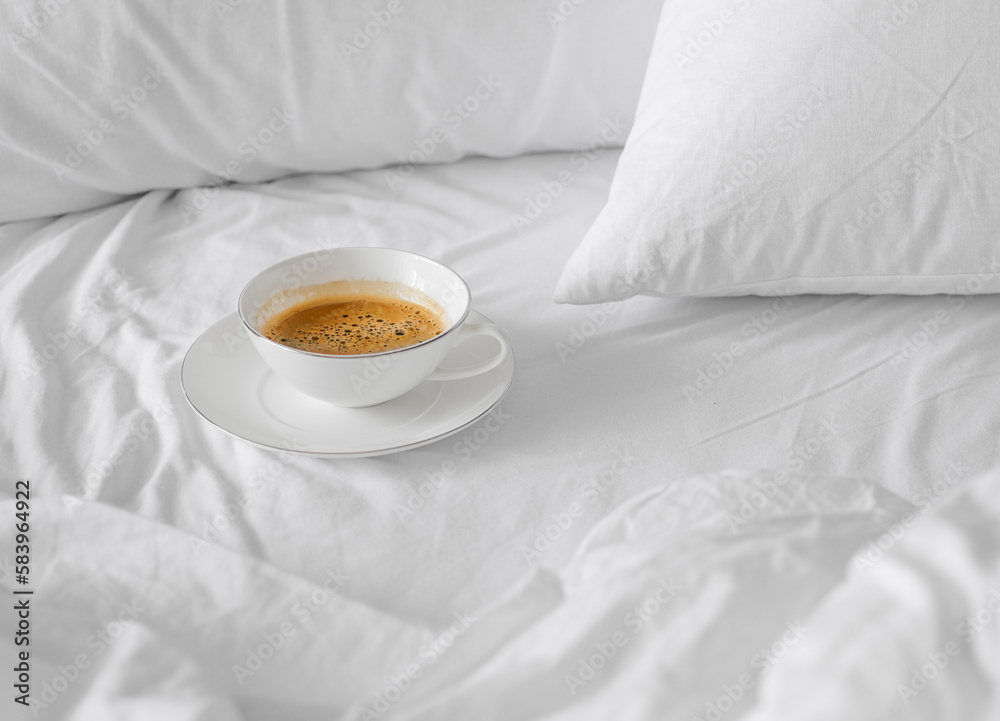 Cup of espresso coffee in a white bed