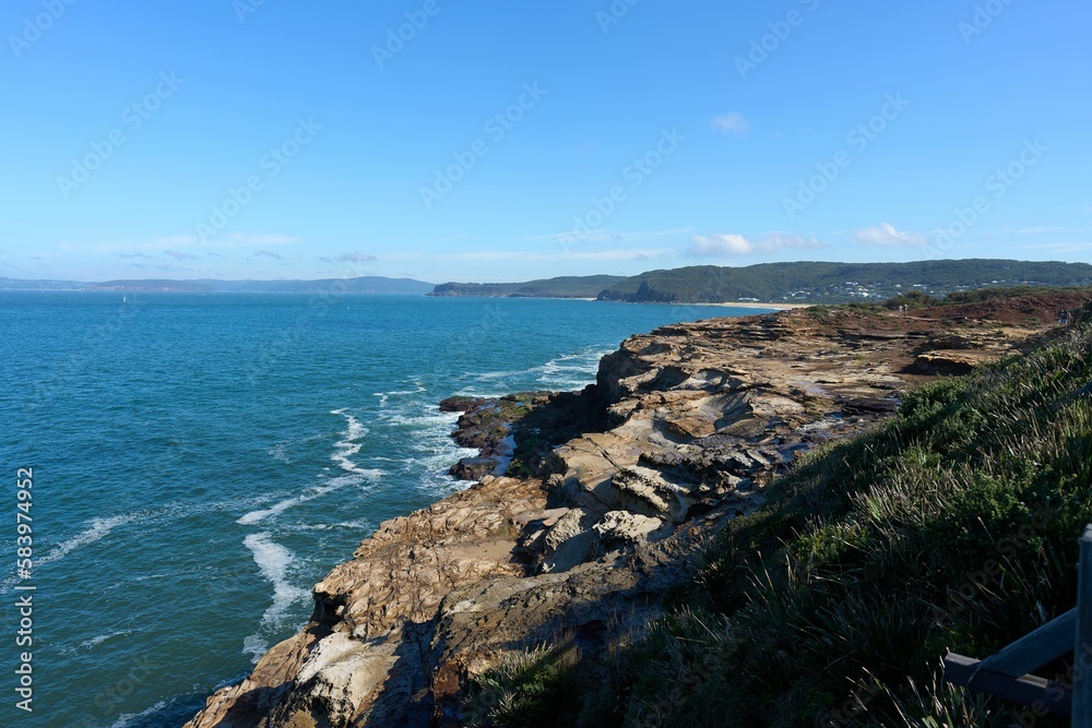 Aerial seascape with coastal rocky cliffs on a sunny day