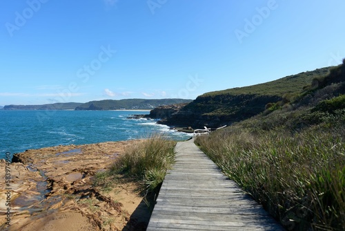 Aerial seascape with coastal rocky cliffs on a sunny day