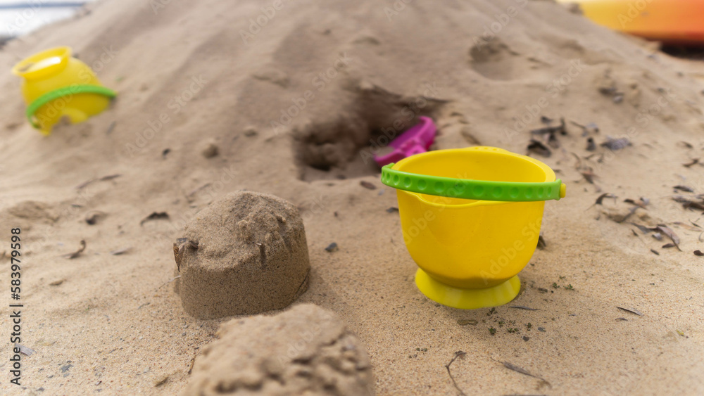 abandoned yellow bucket children's toy lying in the sand abandoned yellow bucket children's toy lying in the sand