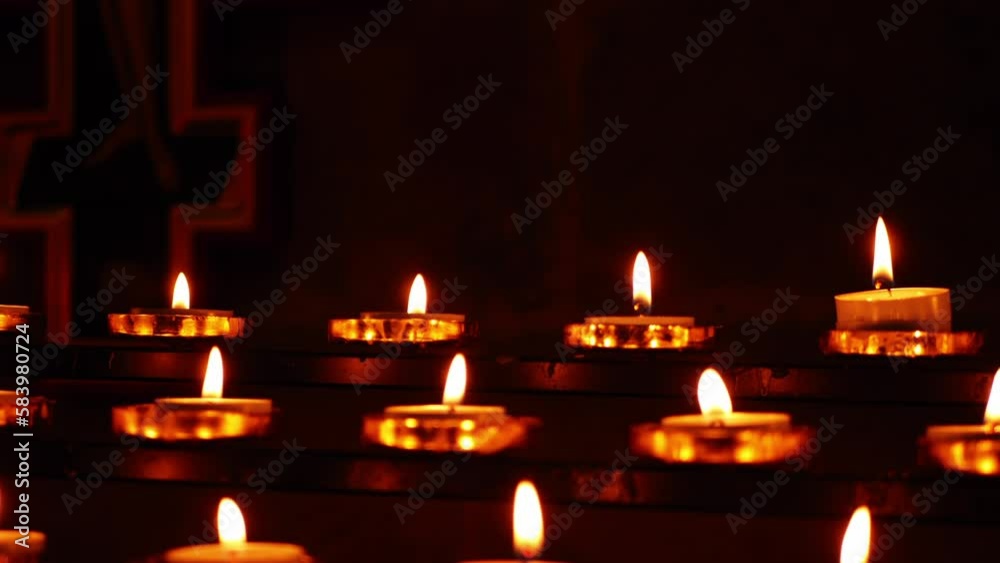 Rows of tea light candles bokeh defocussed burning in a church Rows of tea light candles bokeh defocussed burning in a church