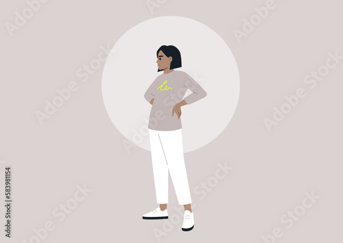 A Hispanic female in her youth standing with her hands on her hips, embodying a casual and modern lifestyle of the millennial generation