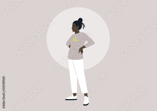 An African female in her youth standing with her hands on her hips, embodying a casual and modern lifestyle of the millennial generation