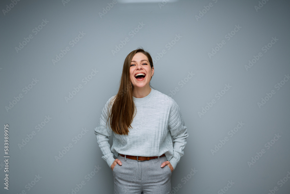 Laughing woman isolated portrait on gray background. Laughing woman isolated portrait on gray background.