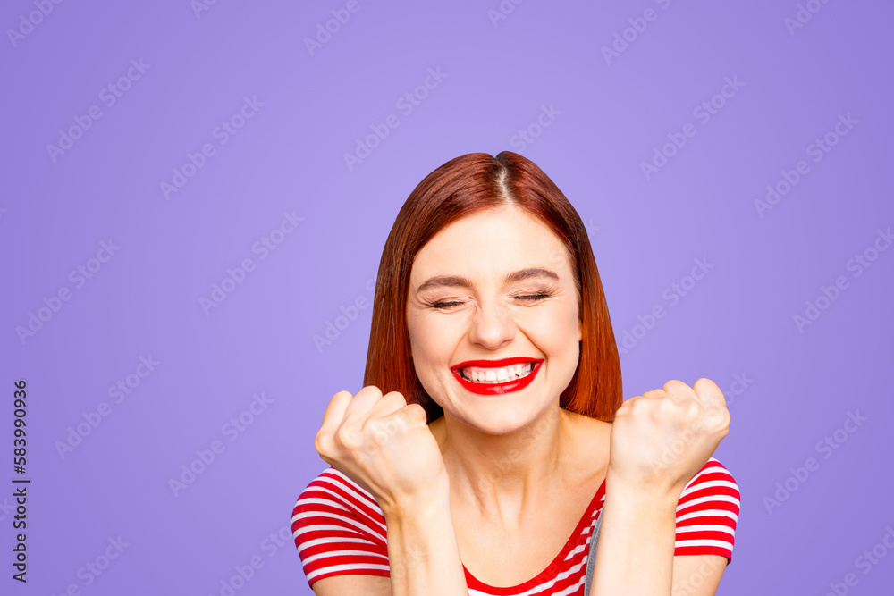 Portrait of nice vivid girlish red straight-haired happy smiling toothy young girl celebrating lottery victory winning, closed eyes, isolated over blue background Portrait of nice vivid girlish red straight-haired happy smiling toothy young girl celebrating lottery victory winning, closed eyes, isolated over blue background