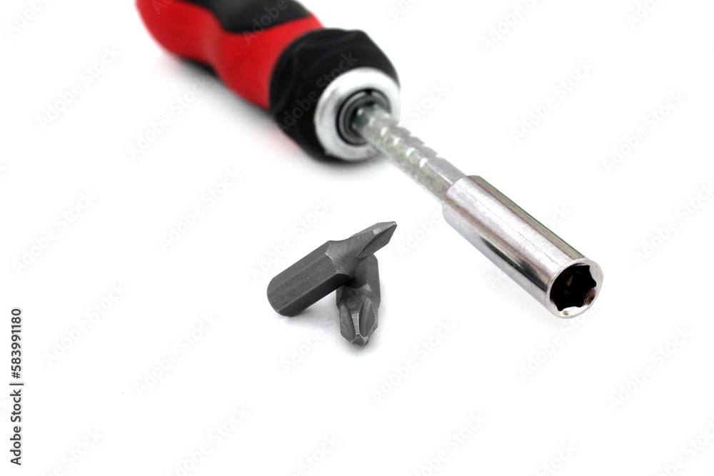 A screwdriver with a removable tip lies on a white isolated background.	