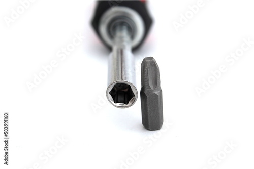  A screwdriver with a removable tip lies on a white isolated background.