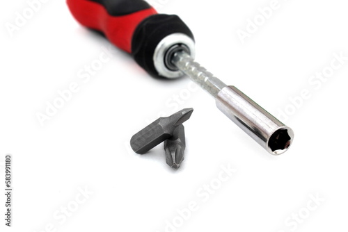 A screwdriver with a removable tip lies on a white isolated background. 