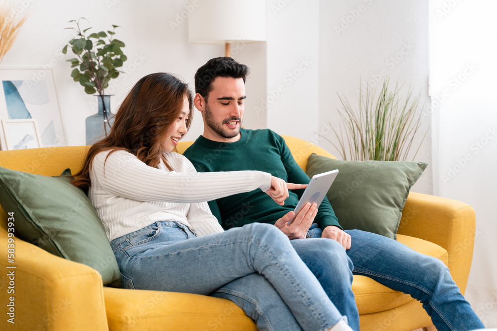 Happy couple using tablet together