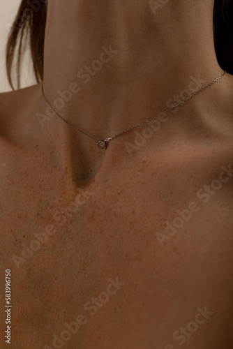 Close-up of the neck and collarbones of a young woman. Skin care, spa treatments.