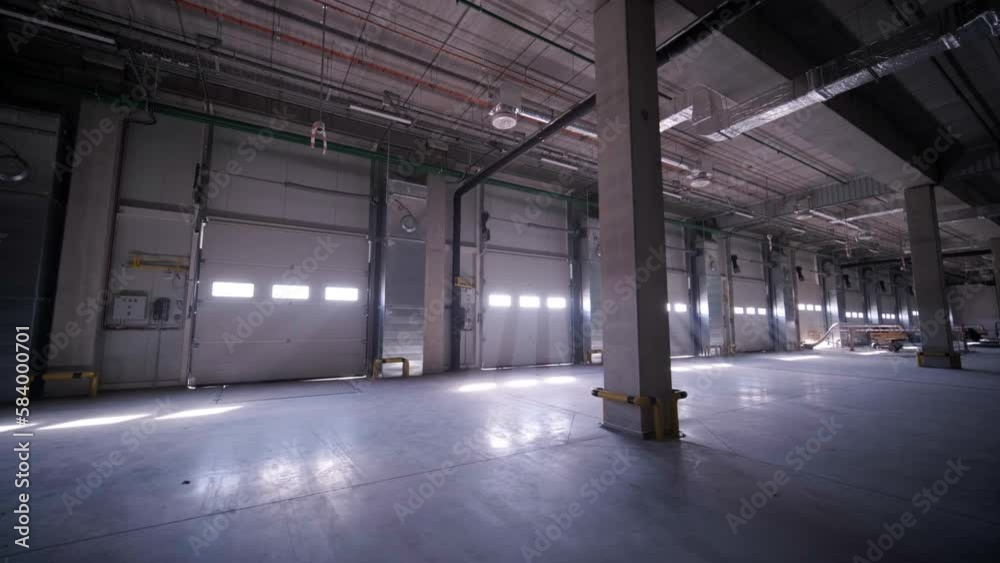 Construction process of a big, modern warehouse with multiple garage gates for easy access and transportation of goods. Construction process of a big, modern warehouse with multiple garage gates for easy access and transportation of goods.