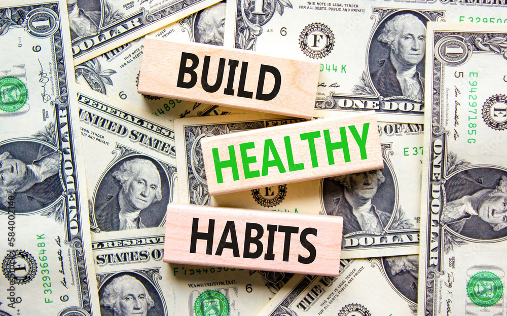 Motivation and Build healthy habits symbol. Concept words Build healthy habits on wooden block on a beautiful background from dollar bills. Business build healthy habits concept. Copy space.