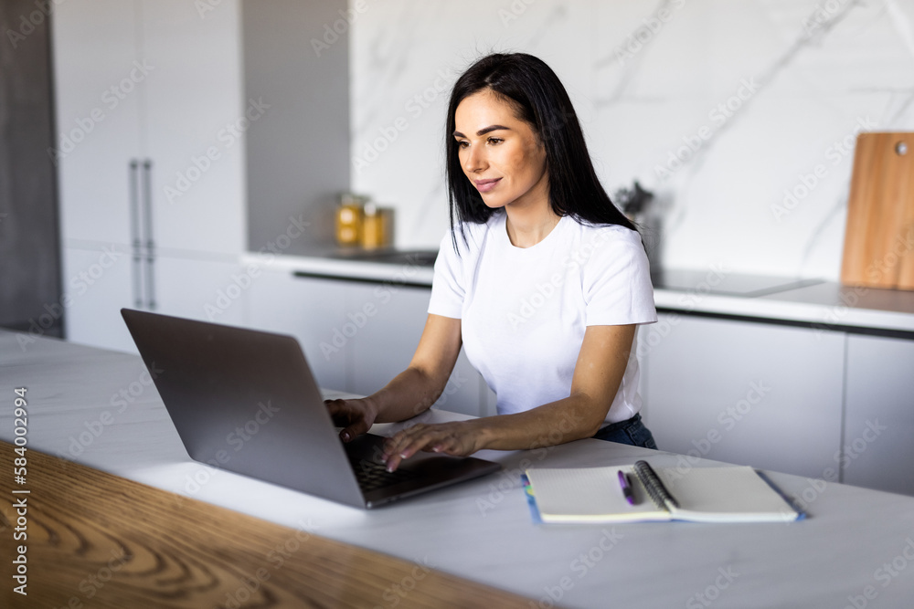 Cute smiling woman using laptop at home. Student girl working on computer. Online shopping, work from home, freelance, online learning, studying, lockdown concept. Distance education Cute smiling woman using laptop at home. Student girl working on computer. Online shopping, work from home, freelance, online learning, studying, lockdown concept. Distance education