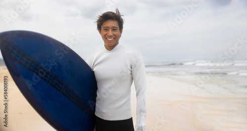 Happy man surfer on the beach with a surfboard. Smiling, Walking