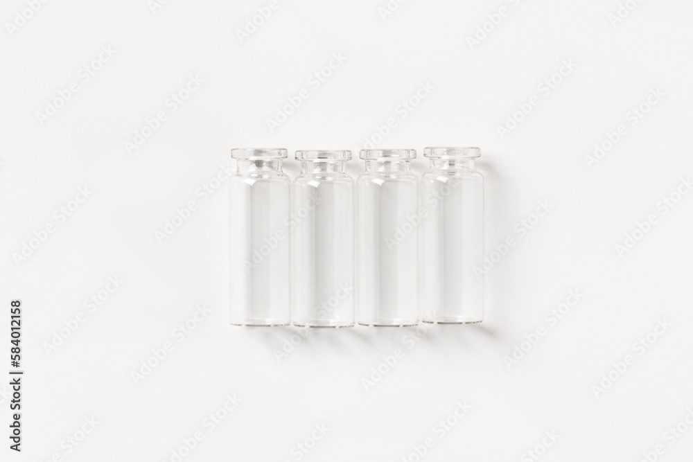 set of empty small glass jars on a light background. View from above.