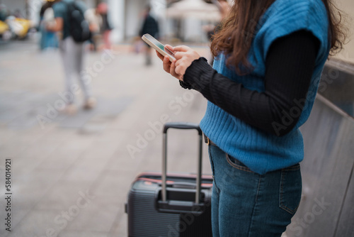 Tourist with luggage using smartphone checking trip for travel..