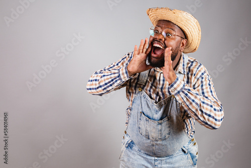 Bild auf Leinwand brazilian black man wearing country clothes from festa junina, festa de são joão