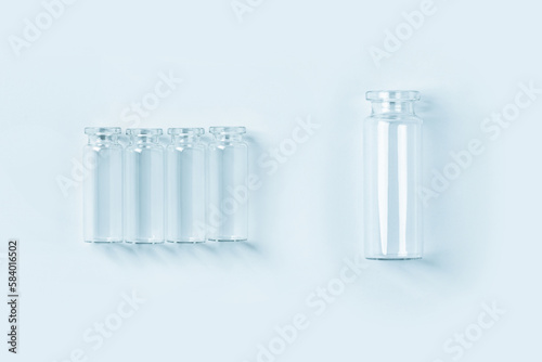 set of empty small blue glass jars on a blue background. View from above.