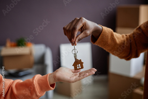Close-up of real estate agent giving keys to owner from new apartment