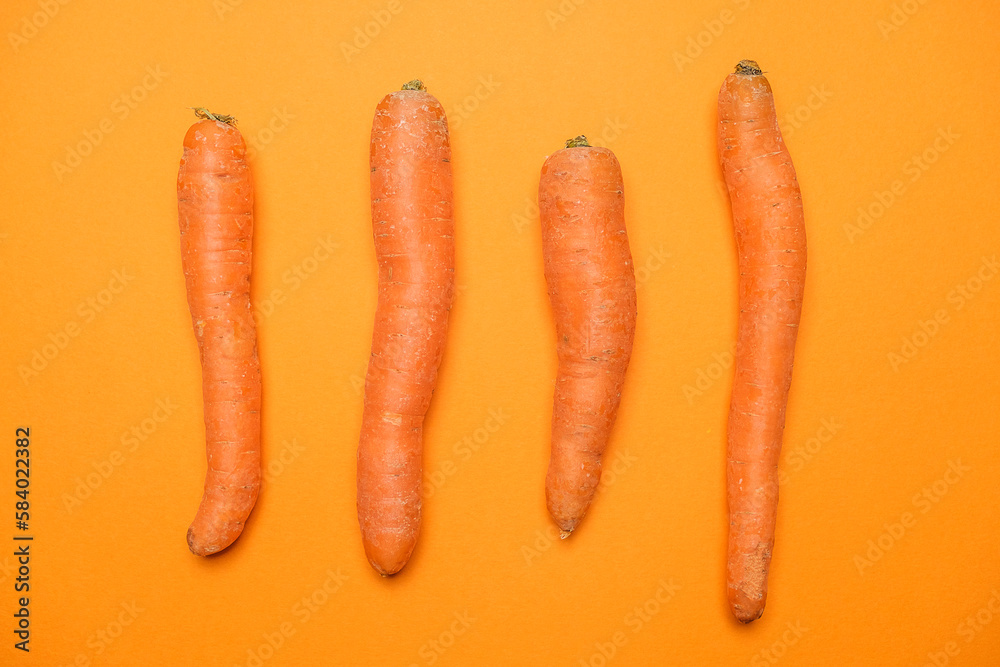 Fresh Carrots isolated on orange background Fresh Carrots isolated on orange background