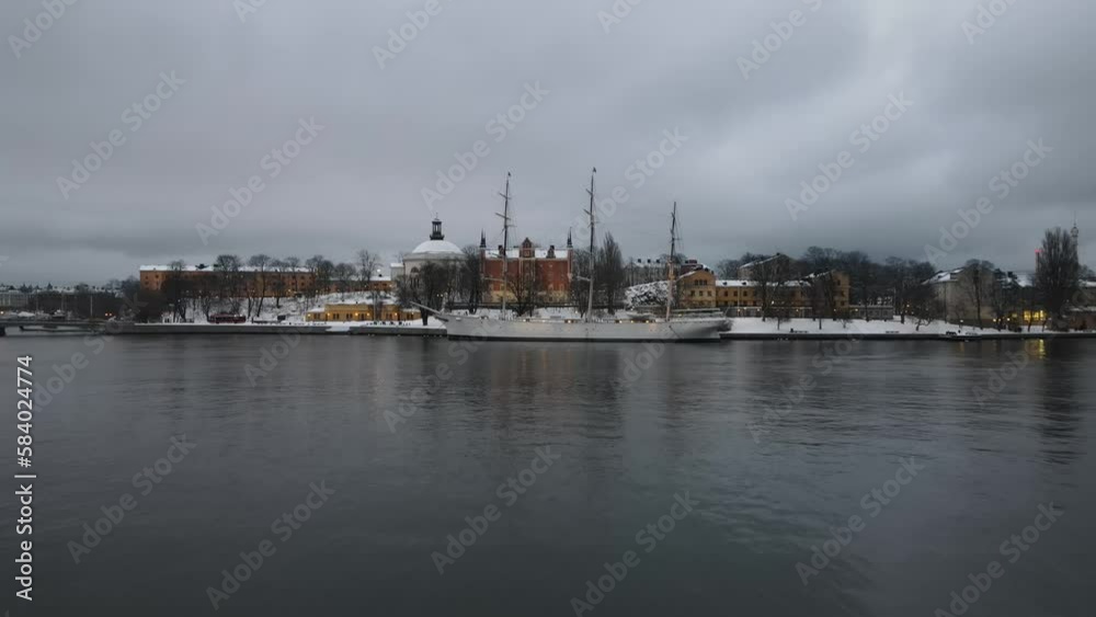 Aerial video of STF Af Chapman & Skeppsholmen Vandrarhem with a Persian ship in the background