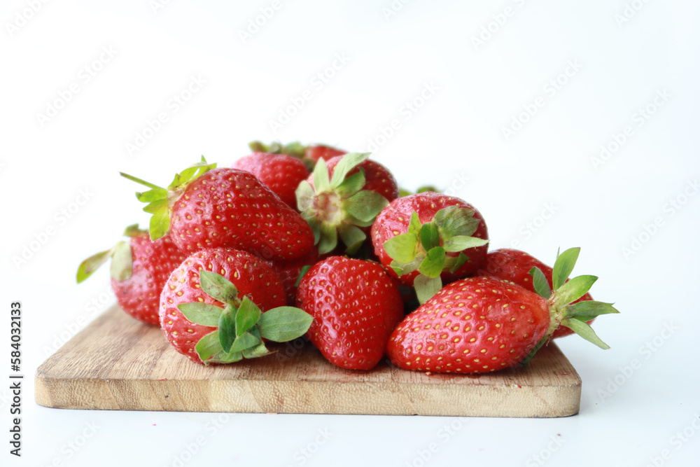 Ripe Red Strawberries on wooden board on table Ripe Red Strawberries on wooden board on table