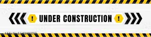 Under construction badge placed on gray background with black and yellow line striped. Attention label with Exclamation mark on hexagon. Vector illustration