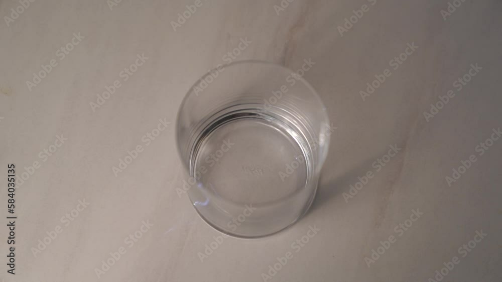 Slow motion video of man dropping ice cubes and pouring dark soda in transparent glass. 4K slow motion video Slow motion video of man dropping ice cubes and pouring dark soda in transparent glass. 4K slow motion video