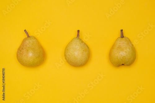 Organic Pear on a yellow. Juicy fruit, cool minimal flat lay, copy space.