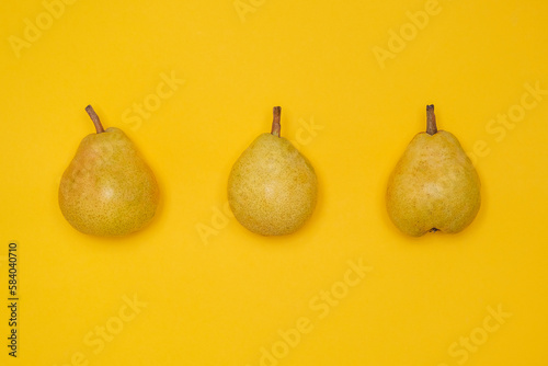 Organic Pear on a yellow. Juicy fruit, cool minimal flat lay, copy space. (ID: 584040710)
