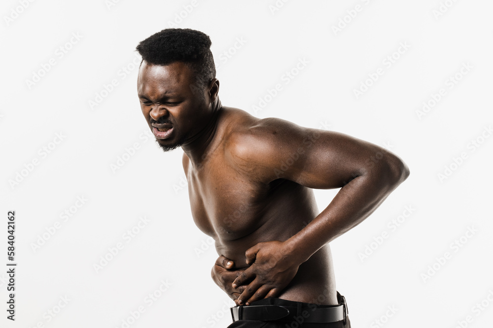 Appendicitis is inflammation of appendix. Muscular shirtless african american man feel abdominal pain, fever, vomiting, and loss of appetite because of appendicitis inflammation. Appendicitis is inflammation of appendix. Muscular shirtless african american man feel abdominal pain, fever, vomiting, and loss of appetite because of appendicitis inflammation.