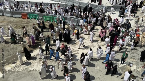 Mecca , Saudi Arabia , March 10 2023: muslim Pilgrims performing umra and walking in Al Haram Mosque - makkah city 4k video photo