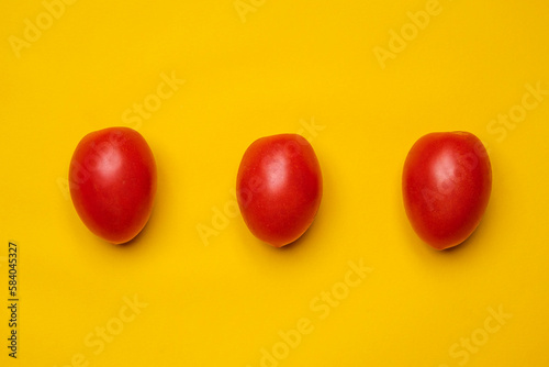 San marzano DOP cherry tomato, little tomatoes on a yellow background. Cool minimal flat lay copy space (ID: 584045327)