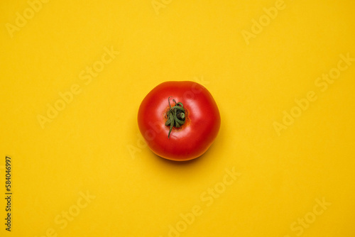 Red Tomato fresh organically grown on a yellow background. Cool minimal flat lay, copy space (ID: 584046997)