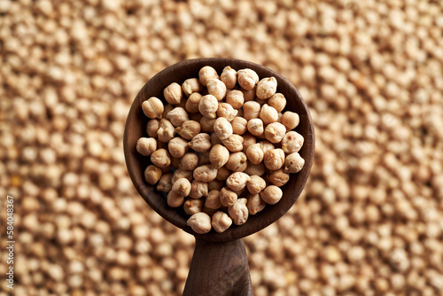 Dry chickpeas or garbanzo beans on a spoon photo