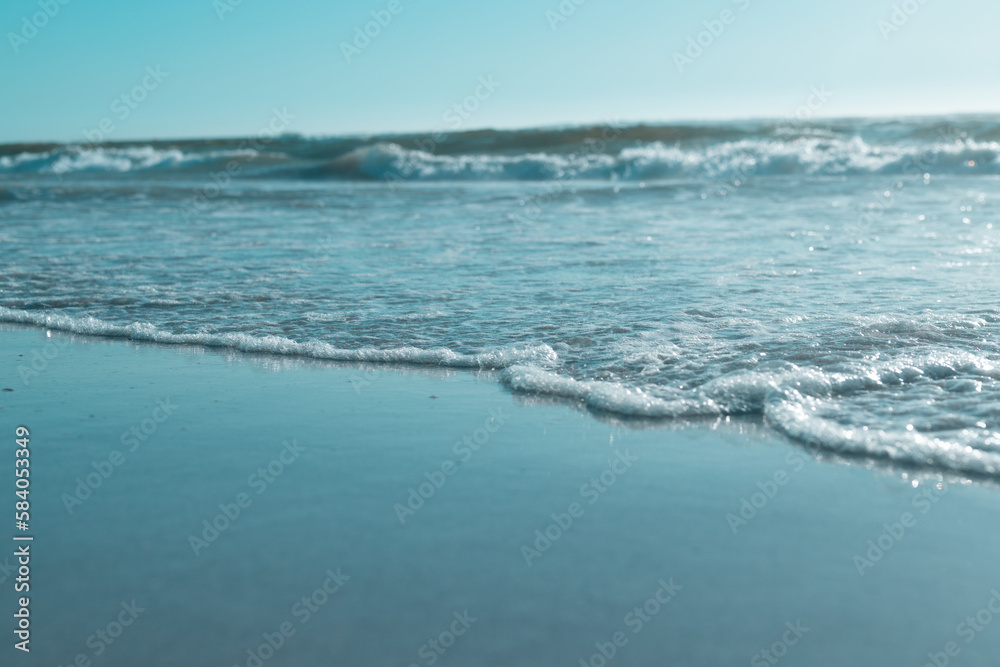 Scenic view of waves splashing on shore and beautiful seascape against clear sky, copy space