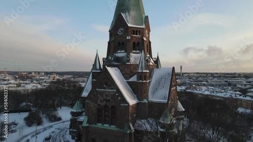 Aerial video above Sofia kyrka church in Stockholm Sweden. The capital city is covered in snow photo