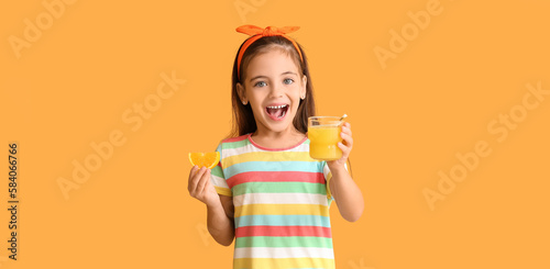 Happy little girl with orange juice on color background