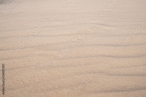 The sea sand after the wind. Silence and peace, sand pattern. Background for quotes.