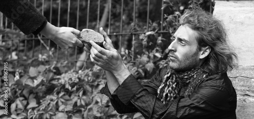 Woman giving bread to poor ...