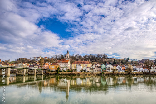 High dynamic range cityscape view of Passau city with view at the river inn and Innstadt district with church St. Gertraud in late afternoon sunlight in march