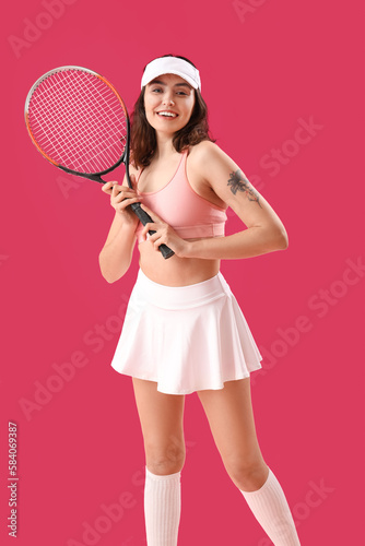Young woman with tennis racket on pink background © Pixel-Shot