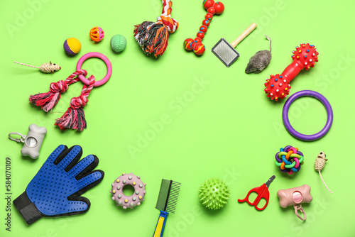 Frame made of pet care accessories on green background