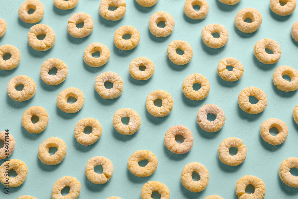 Many yellow cereal rings on blue background Many yellow cereal rings on blue background