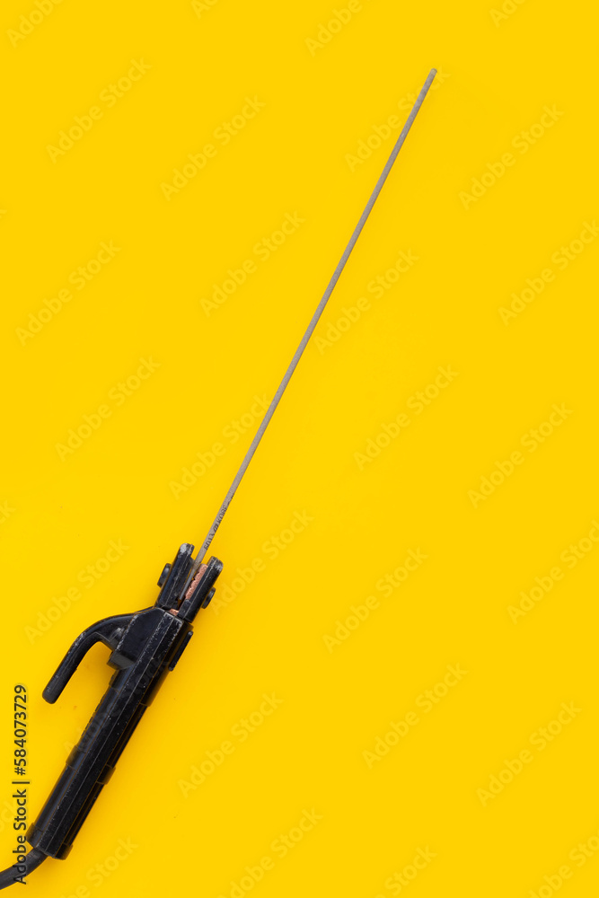 Welding equipment on yellow background.