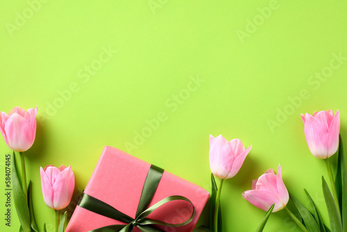 Fototapeta Naklejka Na Ścianę i Meble -  Flat lay composition with tulips and gift box on green background. Happy Mother Day concept