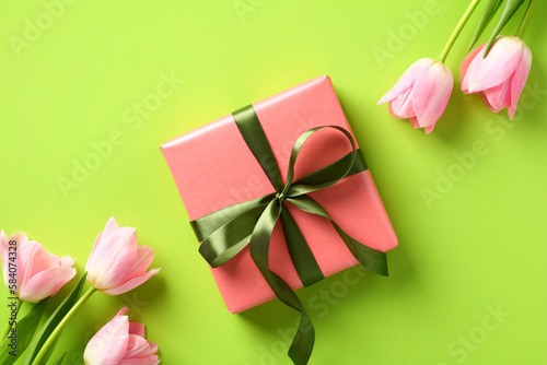 Happy Mother Day concept. Flat lay gift box with tulips flowers on green background © photoguns
