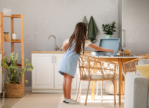 Little girl with record pla...