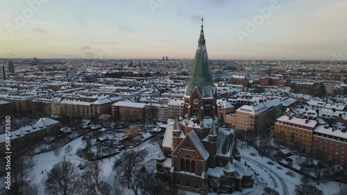 Aerial video above Sofia kyrka church in Stockholm Sweden. The capital city is covered in snow photo